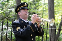 Sergeant Luke Washburn, a bugler with the 338th Army Band of the 88th Regional Support Command, plays Taps on the bugle during a wreath laying ceremony honoring former President Rutherford B. Hayes in Fremont, Ohio October 8, 2017.