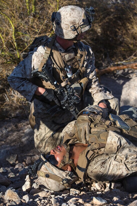 A Marine provides medical care to a simulated casualty during a weapons and tactics instructor course.