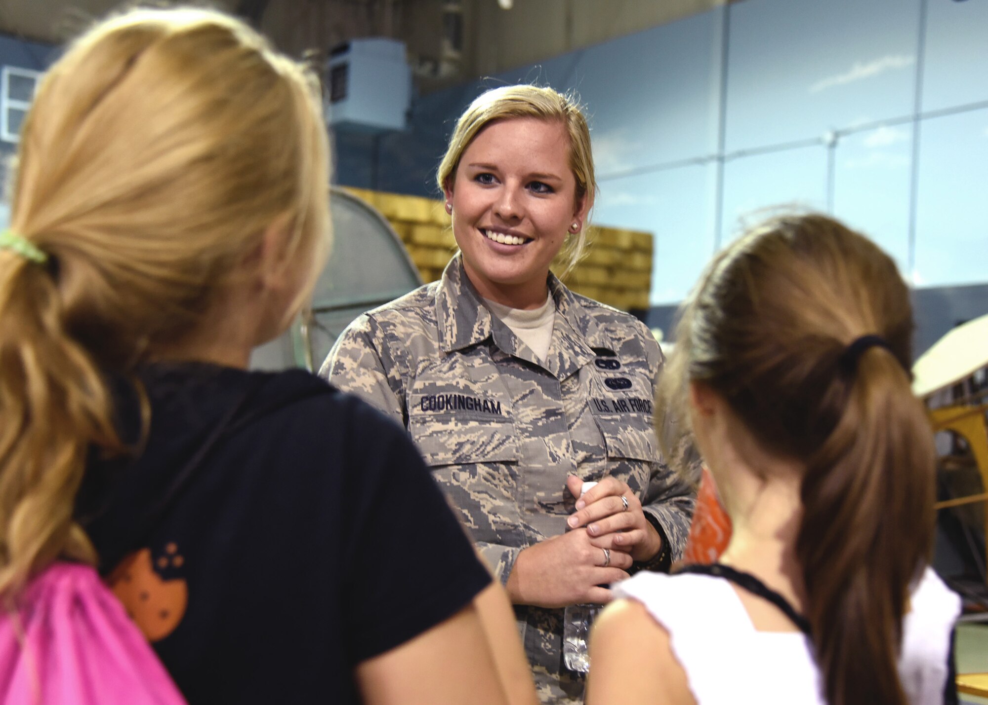 Staff Sgt. Tatiana Cookingham of the 117th Maintenance Squadron talks to young women during the Women in Aviation event at the Southern Museum of Flight