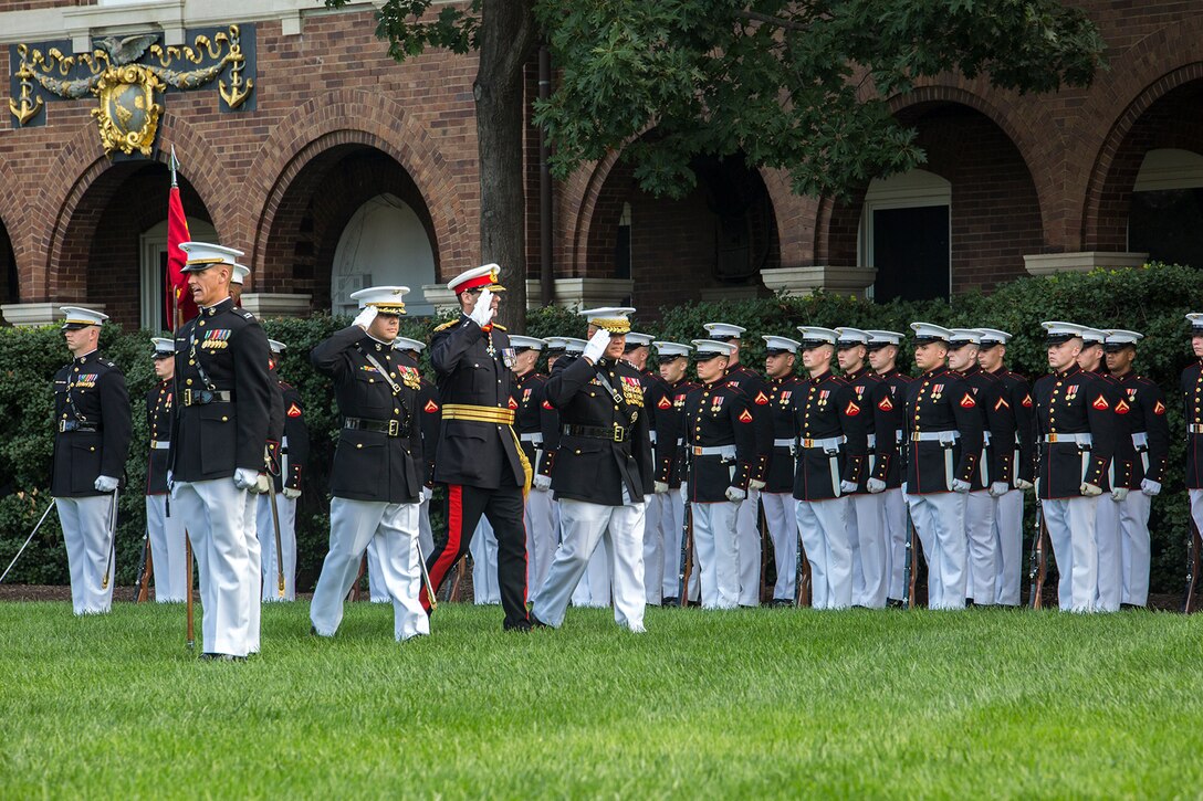 The Commandant of the Marine Corps, Gen. Robert B. Neller, Commandant General of the British Royal Marines, Maj. Gen. Robert A. Magowan, and Maj. Matthew Peterson, parade commander, render a salute during a Troop Review Ceremony for General Magowan at Marine Barracks Washington D.C., October 10, 2017. Magowan is the Commandant of General Royal Marines and the Commander of the United Kingdom Amphibious Forces. The hosting official for the ceremony was General Neller. (Official Marine Corps photo by Cpl. Robert Knapp/Released)