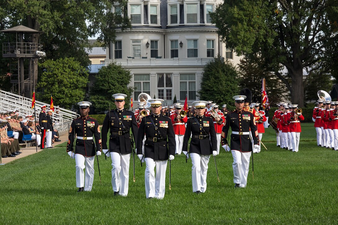 Marines of the parade staff with Marine Barracks Washington D.C. march across the parade deck during a Troop Review Ceremony for Commandant General of the British Royal Marines, Maj. Gen. Robert A. Magowan, at the Barracks, October 10, 2017. General Magowan is the Commandant of General Royal Marines and the Commander of the United Kingdom Amphibious Forces. The hosting official for the ceremony was the Commandant of the Marine Corps, Gen. Robert B. Neller. (Official Marine Corps photo by Cpl. Robert Knapp/Released)