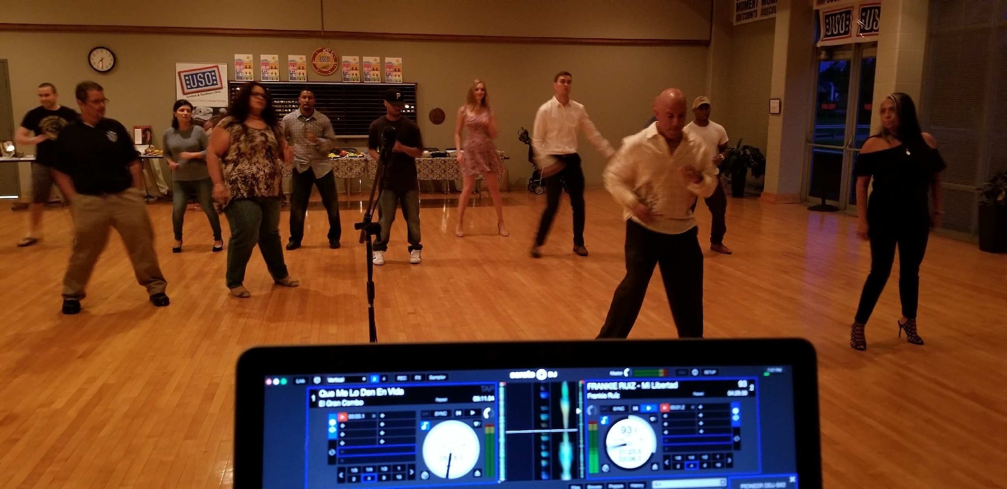 Miguel Maldonado (right of center), Air Force Research Laboratory Fuels and Energy branch chief, provides free dance lessons at a Latin Night at the Wright-Patterson USO in celebration of Hispanic Heritage Month Oct. 7, 2017. AFRL recruited Maldonado from Puerto Rico after college and he’s spent the last 30 years bringing Latin culture to the local area.(Courtesy photo/Miguel Maldonado)