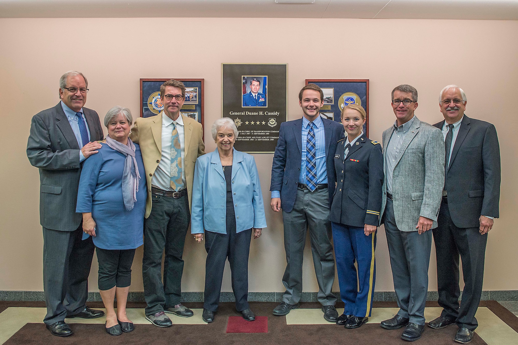 Members of the Cassidy family gather in front of a display honoring Gen. Duane H. Cassidy prior to a dedication ceremony renaming the Global Reach and Planning Center to the Gen. Duane H. Cassidy Conference Center, at Scott Air Force Base, Ill., Oct. 6, 2017.