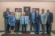 Members of the Cassidy family gather in front of a display honoring Gen. Duane H. Cassidy prior to a dedication ceremony renaming the Global Reach and Planning Center to the Gen. Duane H. Cassidy Conference Center, at Scott Air Force Base, Ill., Oct. 6, 2017.