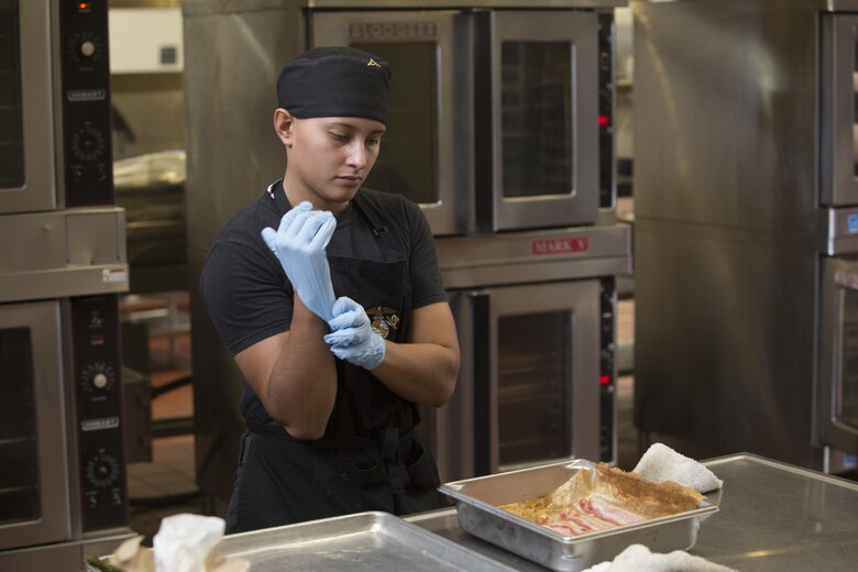 Lance Cpl. Cynthia JaretziCruz, a food service specialist with Headquarters Battalion, Marine Corps Base Hawaii (MCBH), and the winner of the “Chef of the Year” competition at Anderson Hall, MCBH, prepares bacon-wrapped asparagus, Oct. 4, 2017. The competition pitted each winner or runner-up of the “Chef of the Quarter” cook-off against each other in a series of evaluations including a written test, display/presentation, and creativity. (U.S. Marine Corps photo by Lance Cpl. Luke Kuennen)