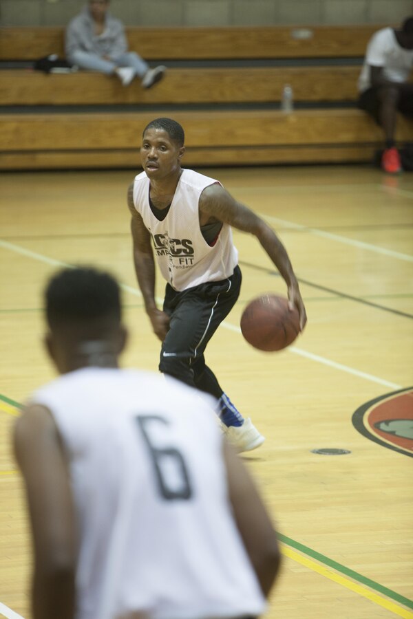 Maurice Givens, the Raiders’ coach, moves the ball down the court during the championship game of the 2017 USAA Commanding General’s Cup basketball tournament at Paige Fieldhouse on Camp Pendleton, Calif., Sept. 28, 2017. 1st Marine Raider Support Battalion, U.S. Marine Corps Forces, Special Operations Command lost to Assault Amphibian School Battalion 84-74 and breaking their 13-0 winning streak. (U.S. Marine Corps photo by Cpl. Bryann K. Whitley)
