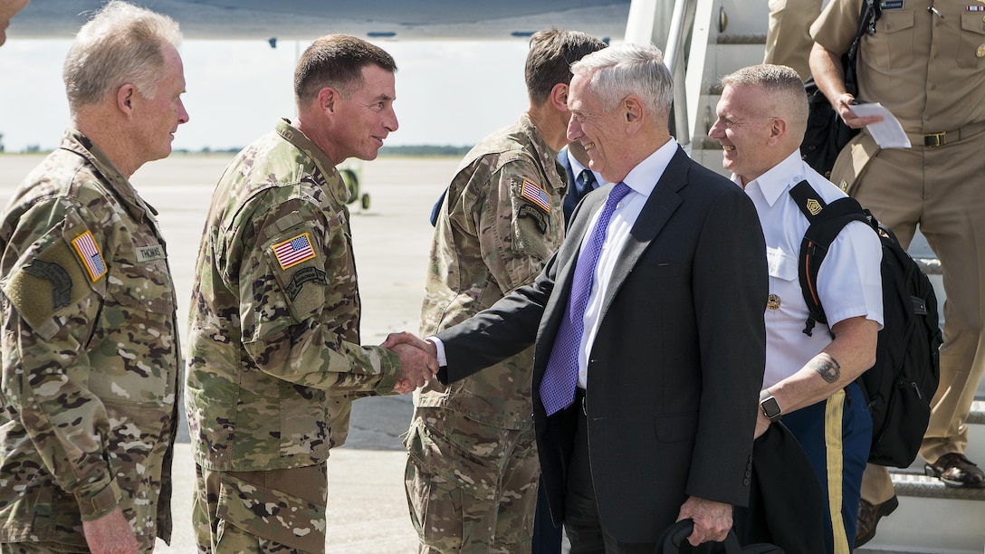 Defense Secretary Jim Mattis shakes hands with an airman.