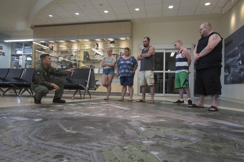 Lt. Col. Mark Angersbach, the commanding officer of Marine Corps Air Station (MCAS) Kaneohe Bay, shows Maddox Hyde and his family the terminal’s floor map during their tour of Marine Corps Base Hawaii, (MCBH) Sept. 27, 2017. The Hyde family was led on tours of MCAS Kaneohe Bay, Aircraft Rescue and Firefighting, and took part in various simulators across MCBH as part of Maddox’s wish to see where his father served before he begins his next cycle of cancer treatment. (U.S. Marine Corps photo by Lance Cpl. Luke Kuennen)