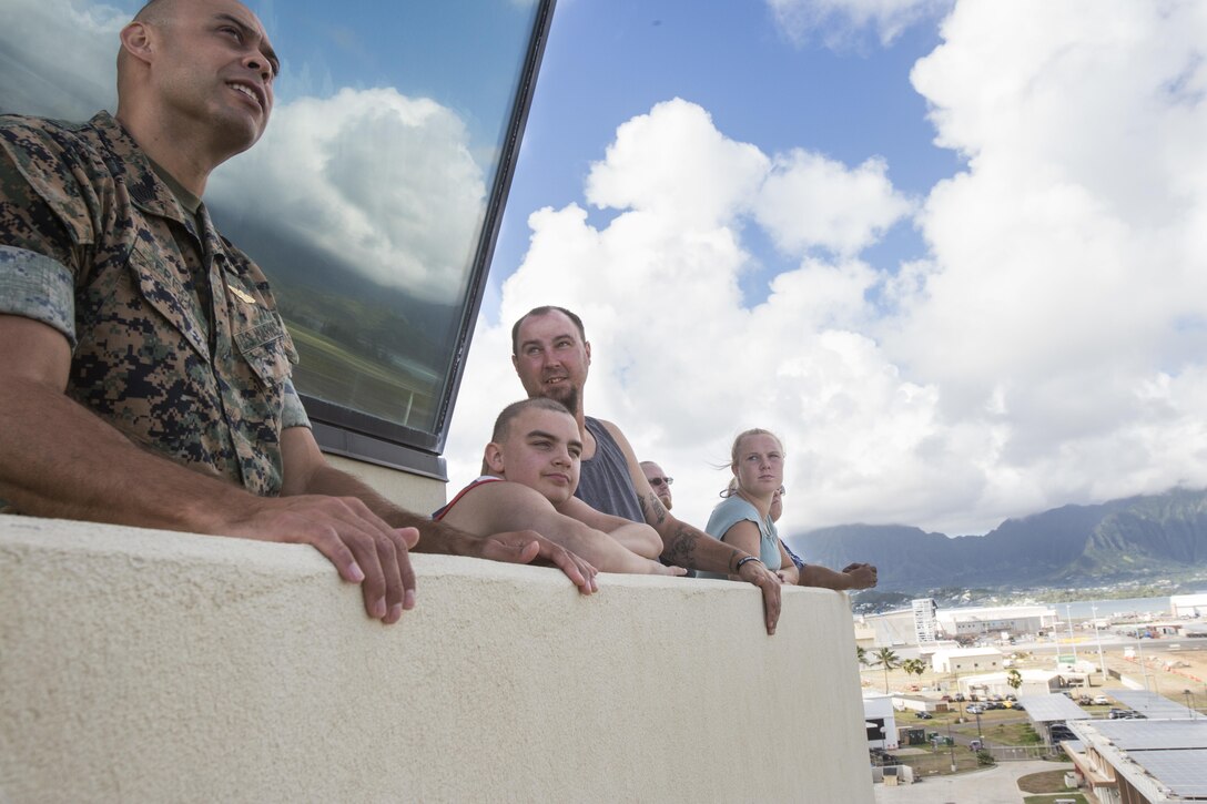 Maddox Hyde and his family watch aircraft land and take off from the catwalk of the air traffic control tower during a tour of Marine Corps Base Hawaii, (MCBH) Sept. 27, 2017. The Hyde family was led on tours of Marine Corps Air Station Kaneohe Bay, Aircraft Rescue and Firefighting, and took part in various simulators across MCBH as part of Maddox’s wish to see where his father served before he begins his next cycle of cancer treatment. (U.S. Marine Corps photo by Lance Cpl. Luke Kuennen)