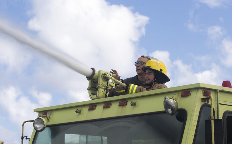 Maddox Hyde sprays water from an Aircraft Rescue and Firefighting (ARFF) truck during a tour of Marine Corps Base Hawaii, (MCBH) Sept. 27, 2017. The Hyde family was led on tours of Marine Corps Air Station Kaneohe Bay, ARFF, and took part in various simulators across MCBH as part of Maddox’s wish to see where his father served before he begins his next cycle of cancer treatment. (U.S. Marine Corps photo by Lance Cpl. Luke Kuennen)