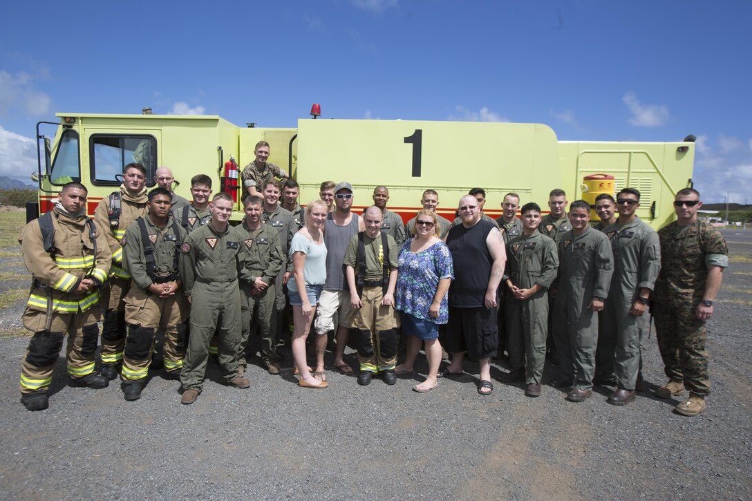 Maddox Hyde and his family pose for a photo with the Marines of Aircraft Rescue and Firefighting (ARFF) during their tour of Marine Corps Base Hawaii, (MCBH) Sept. 27, 2017. The Hyde family was led on tours of Marine Corps Air Station Kaneohe Bay, ARFF, and took part in various simulators across MCBH as part of Maddox’s wish to see where his father served before he begins his next cycle of cancer treatment. (U.S. Marine Corps photo by Lance Cpl. Luke Kuennen)