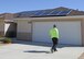 Contractors work to install solar panels on this house in the Tamarisk Plains neighborhood on Edwards Air Force Base. Workers will install solar panels on 368 homes on the base beginning with vacant homes first. (U.S. Air Force photo by Kenji Thuloweit)