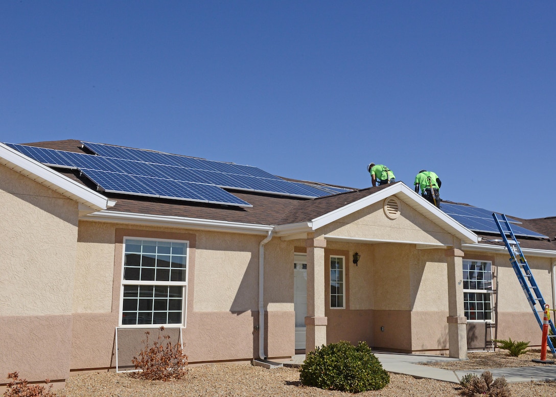 Contractors work to install solar panels on this house in the Tamarisk Plains neighborhood on Edwards Air Force Base. Workers will install solar panels on 368 homes on the base beginning with vacant homes first. (U.S. Air Force photo by Kenji Thuloweit)