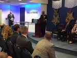 Navy Vice Adm. Kevin D. Scott, the Joint Staff's director of joint force development, congratulates the recipients chosen to share a $200,000 donation from the Newman's Own Foundation.
