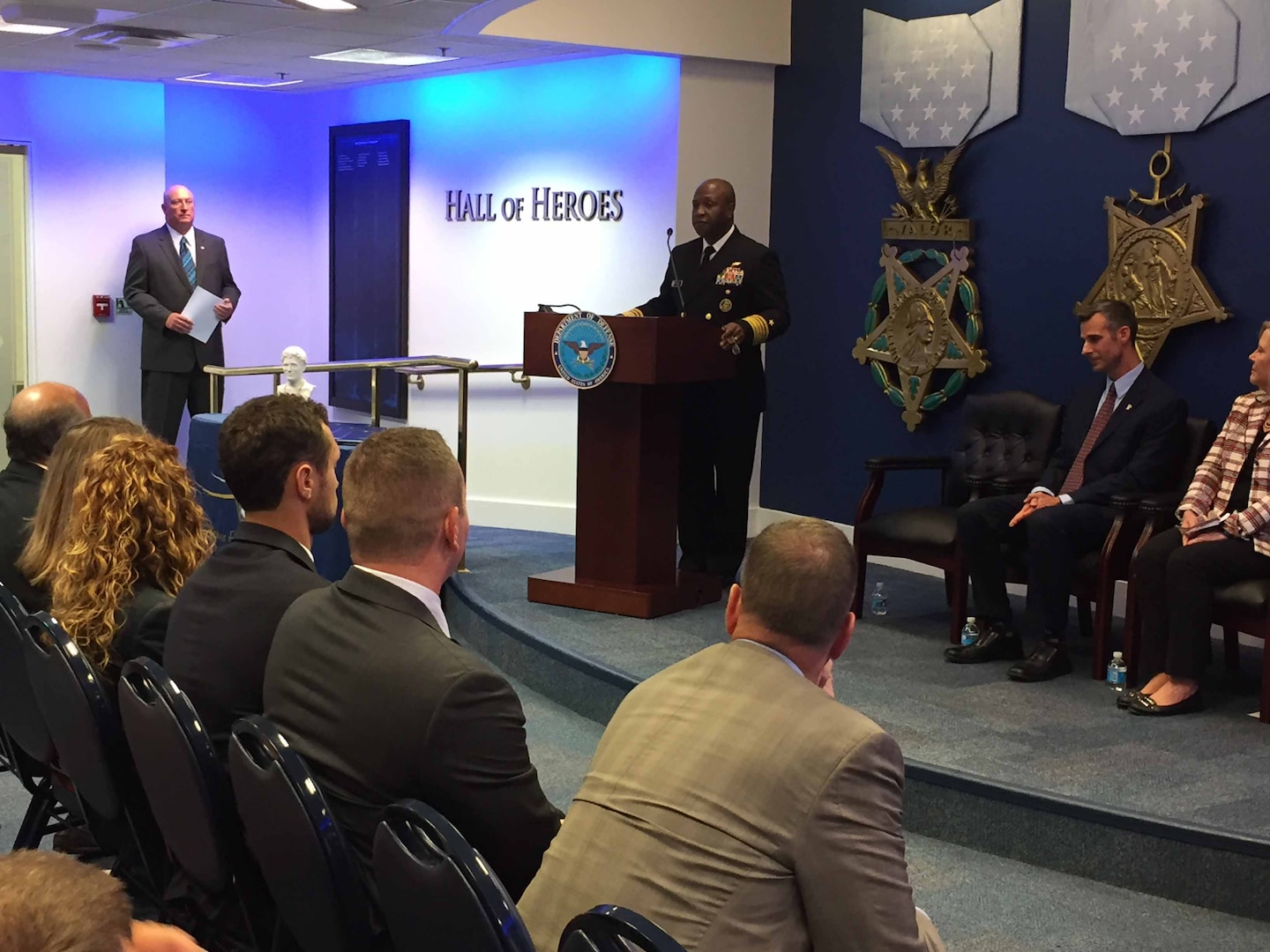Navy Vice Adm. Kevin D. Scott, the Joint Staff's director of joint force development, congratulates the recipients chosen to share a $200,000 donation from the Newman's Own Foundation.