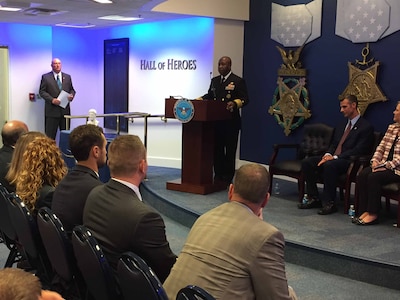 Navy Vice Adm. Kevin D. Scott, the Joint Staff's director of joint force development, congratulates the recipients chosen to share a $200,000 donation from the Newman's Own Foundation.