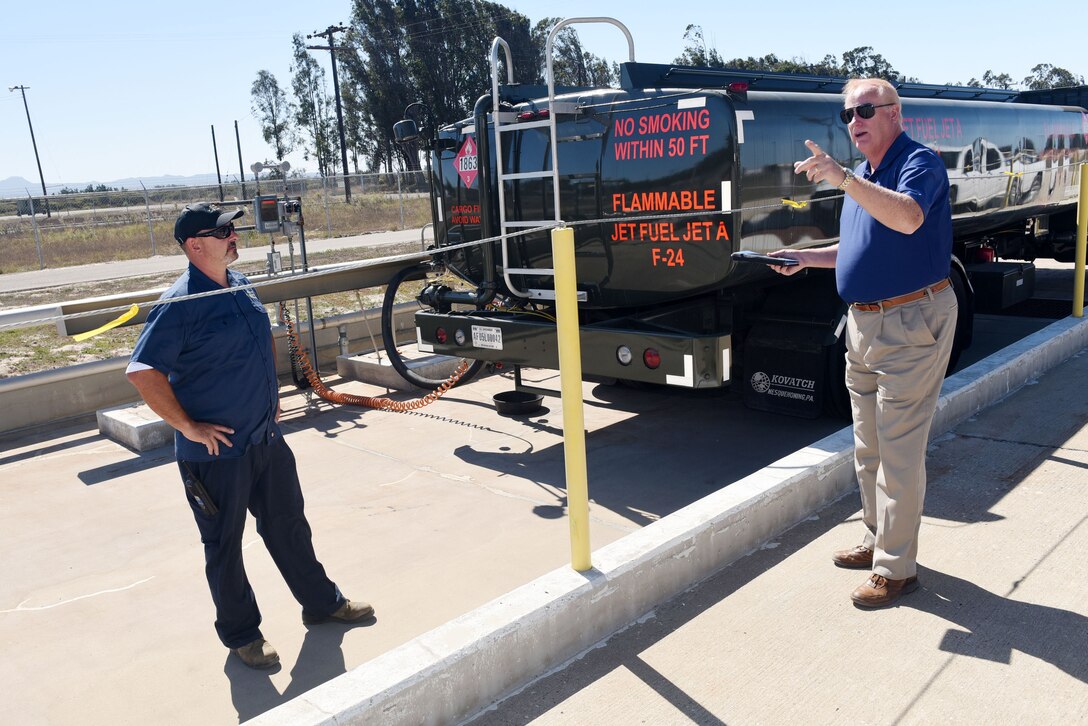 Tracy Taylor, Defense Logistics Agency Energy instructor, trains Jerry Woiton, 30th Logistics Readiness Squadron contractor during a fuel spill exercise, Oct. 6, 2017, at Vandenberg Air Force Base, Calif. DLA Energy provides military installations with the training necessary to prevent and react to disasters, such as this simulated fuel spill, while adhering to federal regulations. (U.S. Air Force photo by Tech. Sgt. Jim Araos/Released)