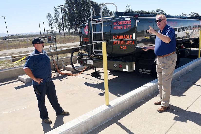 Tracy Taylor, Defense Logistics Agency Energy instructor, trains Jerry Woiton, 30th Logistics Readiness Squadron contractor during a fuel spill exercise, Oct. 6, 2017, at Vandenberg Air Force Base, Calif. DLA Energy provides military installations with the training necessary to prevent and react to disasters, such as this simulated fuel spill, while adhering to federal regulations. (U.S. Air Force photo by Tech. Sgt. Jim Araos/Released)