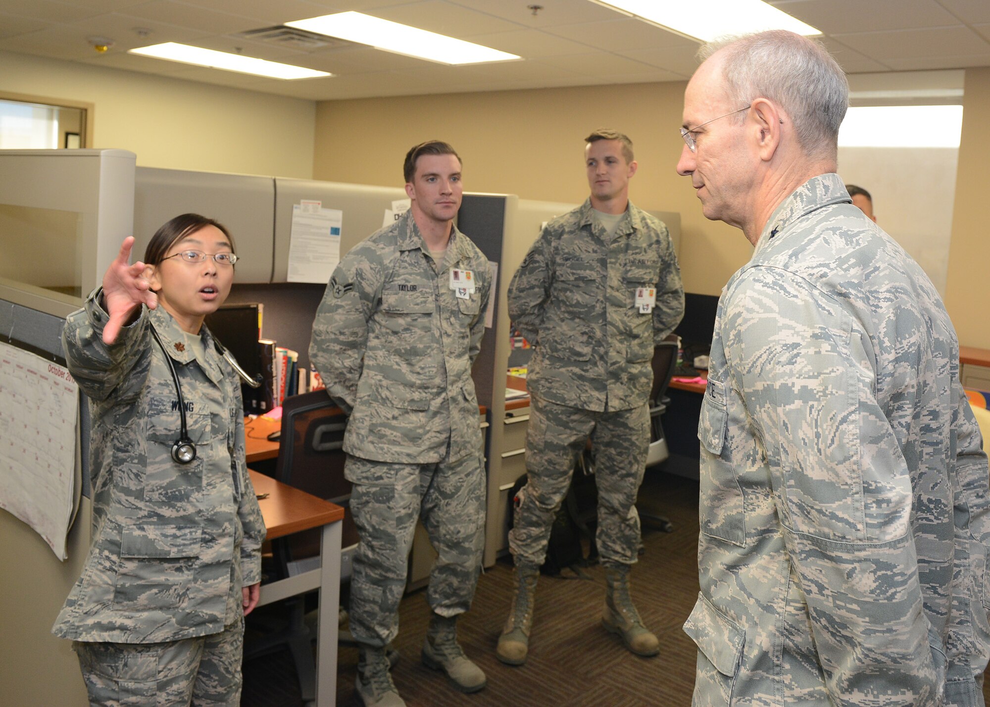 Lt. Gen. Mark Ediger, Headquarters U.S. Air Force Surgeon General, is briefed by Maj. Priscilla Wong, 56th Medical Group allergist, while touring the 56th MDG facility during a site visit at Luke Air Force Base, Ariz., Oct. 11, 2017. Ediger visited Luke to see the new renovations to the 56th MDG and how they support the F-35A Lightning II mission. (U.S. Air Force photo by Senior Airman James Hensley)