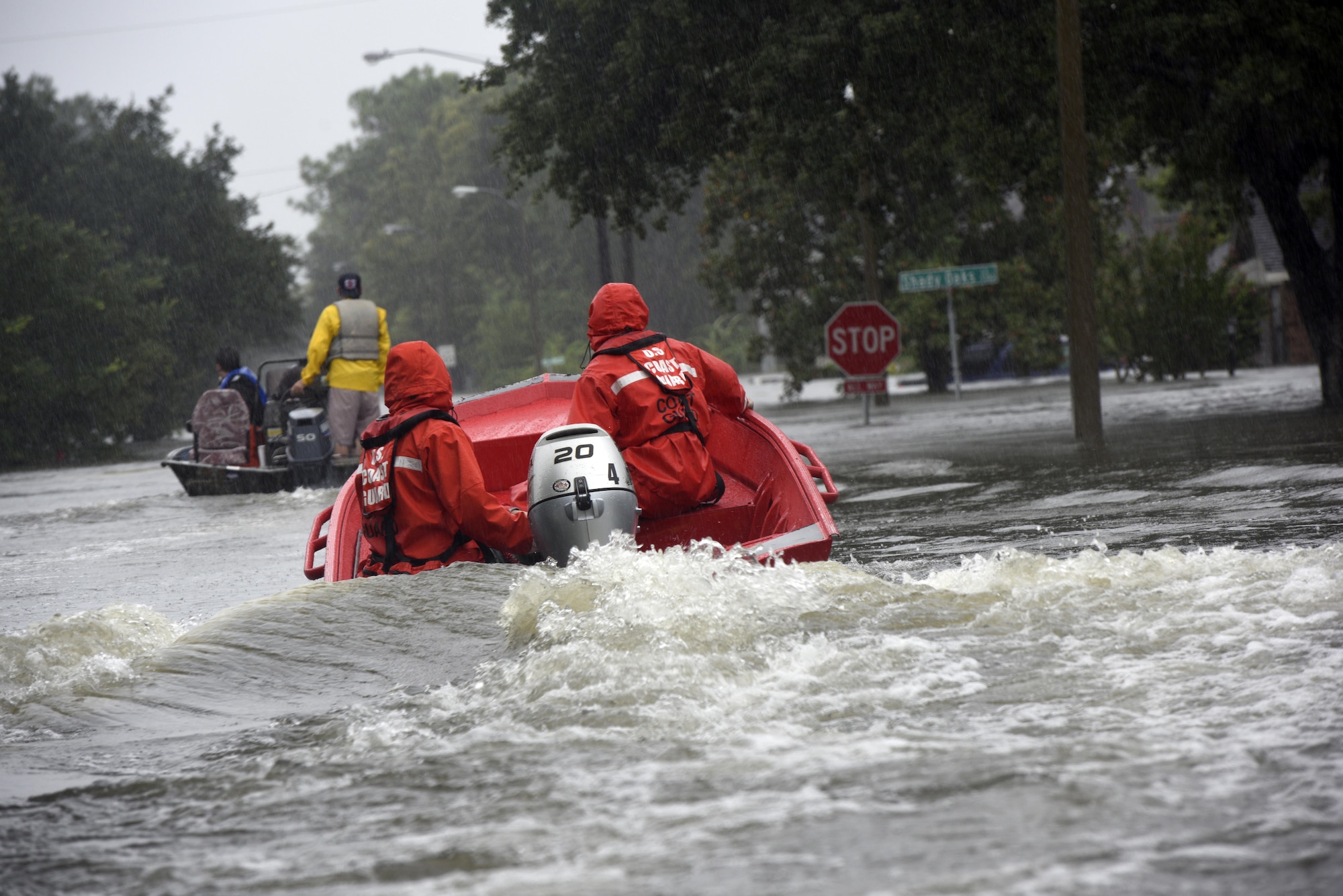 Coast Guard Petty Officers 3rd Class Eric Gordon and Gavin Kershaw pilot a 16-foot flood punt boat and join good Samaritans in patrolling a flooded neighborhood in Friendswood, Texas, Aug. 29, 2017. The flood punt team from Marine Safety Unit Paducah, Kentucky, reported to the greater Houston area on Aug. 25 and have rescued over 850 people. (U.S. Coast Guard photo by Petty Officer 3rd Class Corinne Zilnicki/Released)