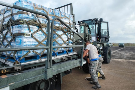 Airmen load water onto a Halvorsen K-loder at Aguadilla.