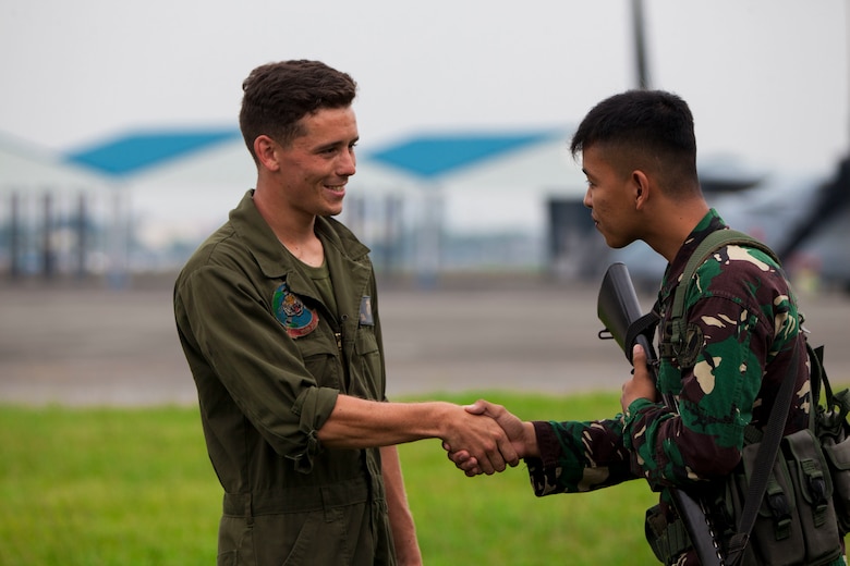 U.S. Marine Lance Cpl. Kleber Leaf, an airframes mechanic with Marine Medium Tiltrotor Squadron 262 (VMM-262), Marine Aircraft Group 36, 1st Marine Aircraft Wing, and Philippine Airman Second Class Arvin Neil D. Barmal, greet each other during an MV-22B Osprey tiltrotor aircraft maintenance repair on Clark Air Base during exercise KAMANDAG, Oct. 5, 2017. Bilateral exercises such as KAMANDAG increase the ability of the United States and the Philippines to rapidly respond and work together during real world terrorist or humanitarian crises, in order to accomplish the mission, support the local population and help mitigate human suffering. (U.S. Marine Corps Photo by Corporal Marimar M. Morales)
