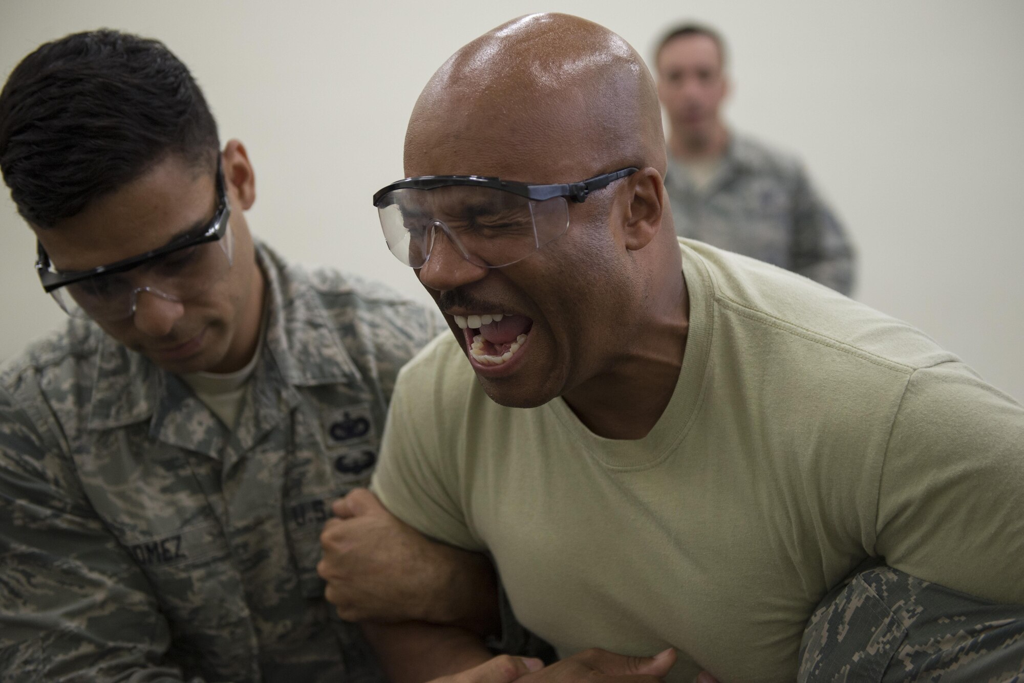 Chief Master Sgt. Elvin Young, 374th Airlift Wing command chief, reacts to being tased during a 374th Security Forces Squadron less-lethal weapons demonstration, Oct. 11, 2017, at Yokota Air Base, Japan.
