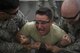 Col. Sergio Vega, 374th Airlift Wing vice commander, is guided to a mat while being tased during a 374th Security Forces Squadron less-lethal weapons demonstration, Oct. 11, 2017, at Yokota Air Base, Japan.