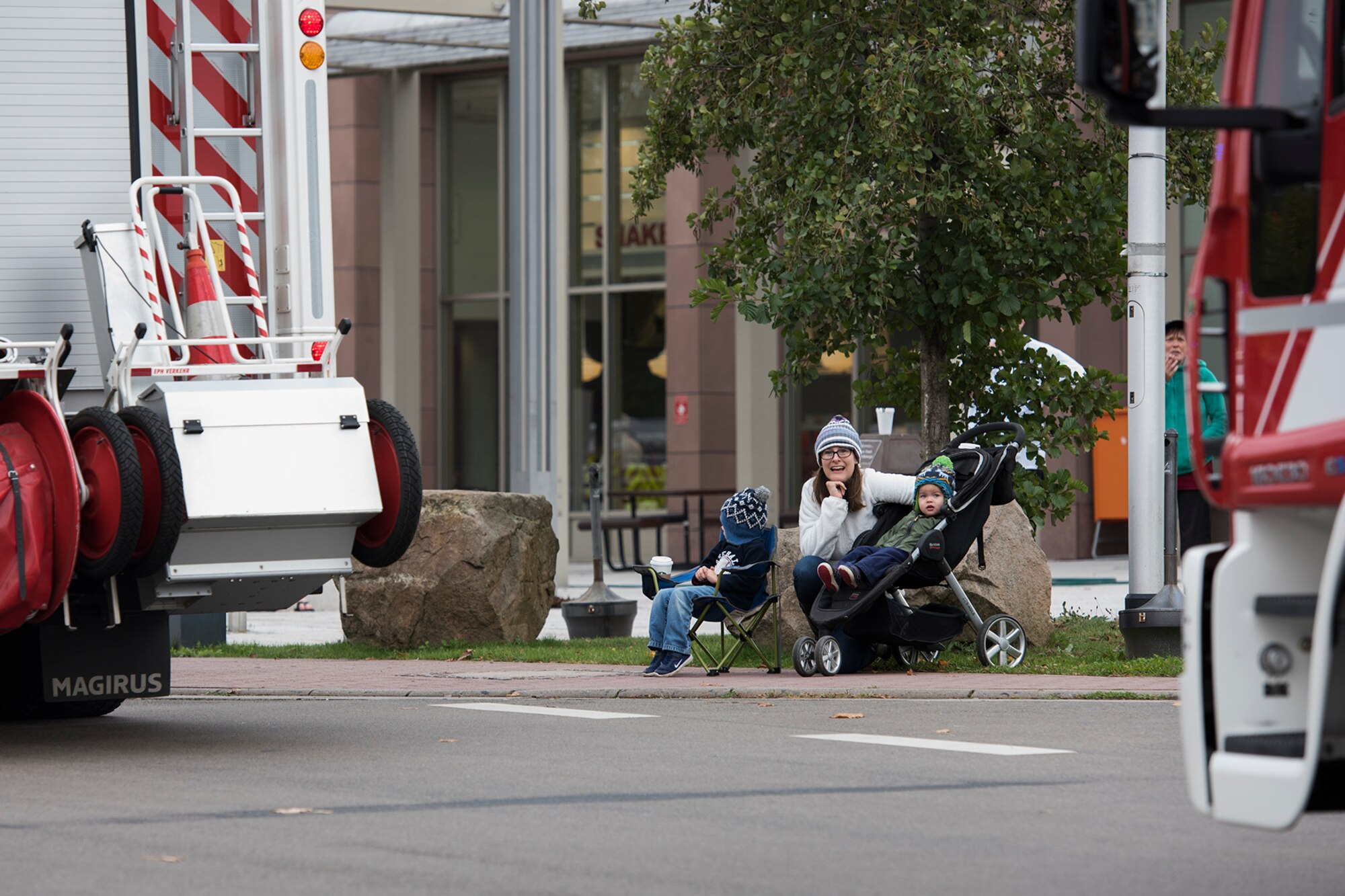 Members of the Kaiserslautern Military Community watch fire trucks pass at the Fire Prevention Week parade on Ramstein Air Base, Germany, Oct. 7, 2017. Fire Departments from Ramstein Village, Landstuhl, Carlsberg, and Technical Relief Foundation (THW) Kaiserslautern, participated in the parade and open house. This year’s theme, “Every second counts, plan two ways out!” encourages families to have more than one exit plan in case of an emergency. (U.S. Air Force photo by Airman 1st Class Devin M. Rumbaugh)