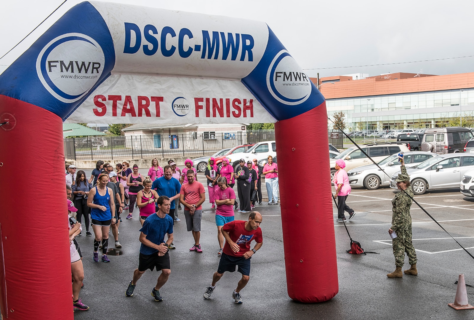 DLA Land and Maritime Commander Navy Rear Adm. Michelle Skubic sounds the horn to officially start the Breast Cancer Awareness Month 5K race at DSCC