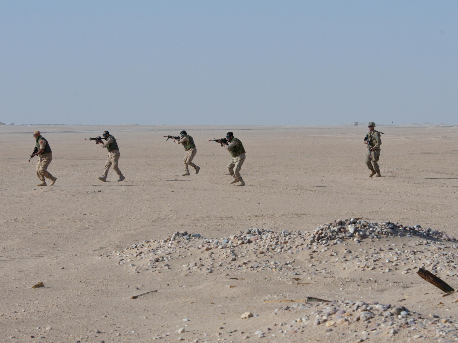 Soldiers in formation with weapons.
