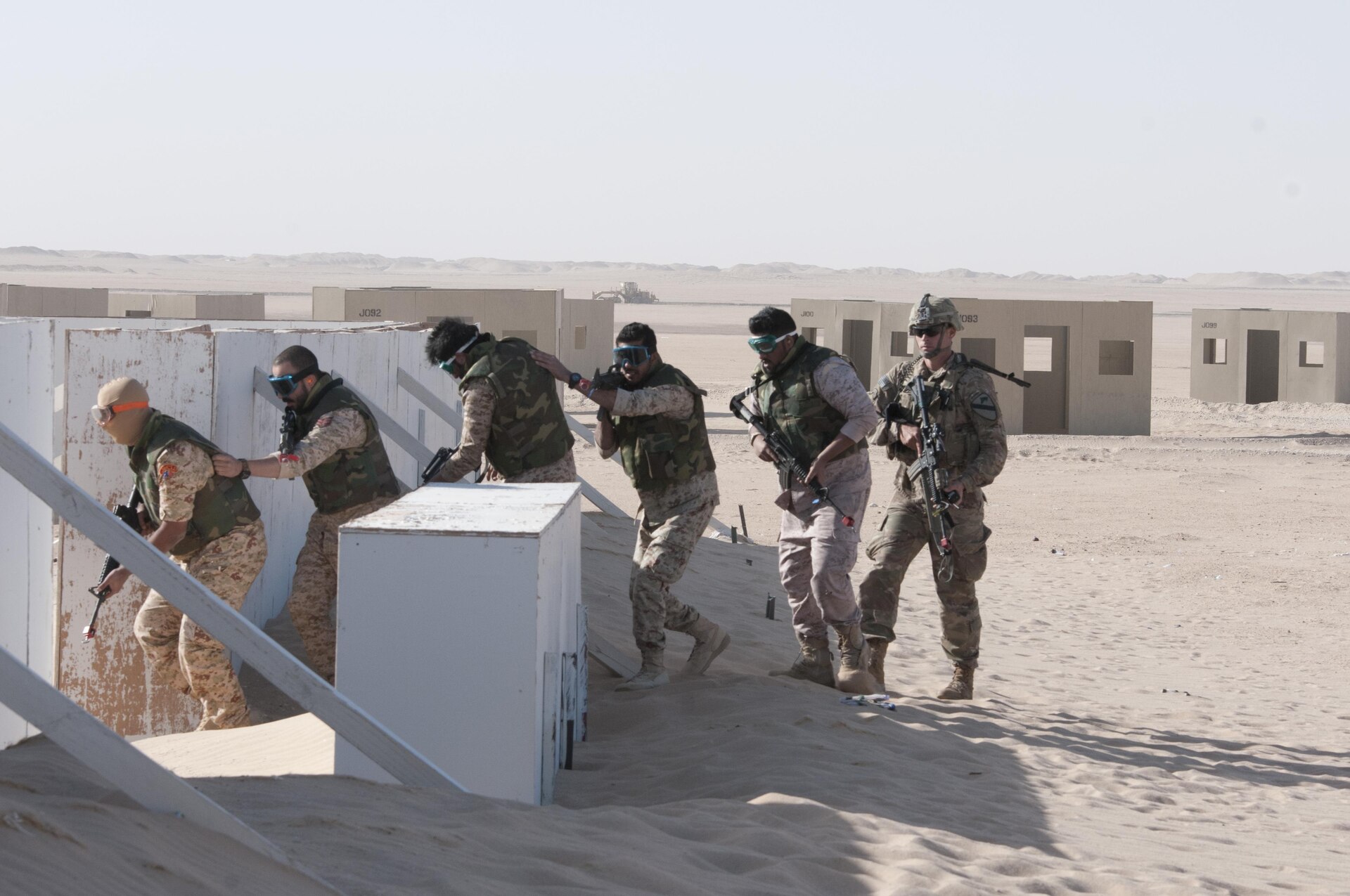 Soldiers follow eachother through the mock village