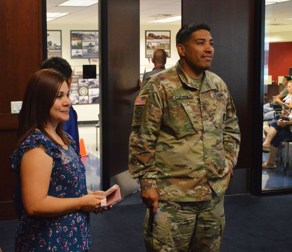 Army Sgt. 1st Class Jaime Guerra, right, a recruiter at Arrowhead Recruiting Center, and his wife, Mayra, smile as they watch their son Anthony (not pictured) perform the Army oath of enlistment at Phoenix Military Entrance Processing Station, Sept. 21, 2017. Army photo by Alun Thomas