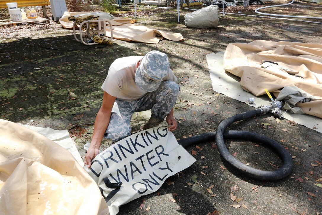An Army Reserve soldier sets up a tactical water purification system in Quebradillas.