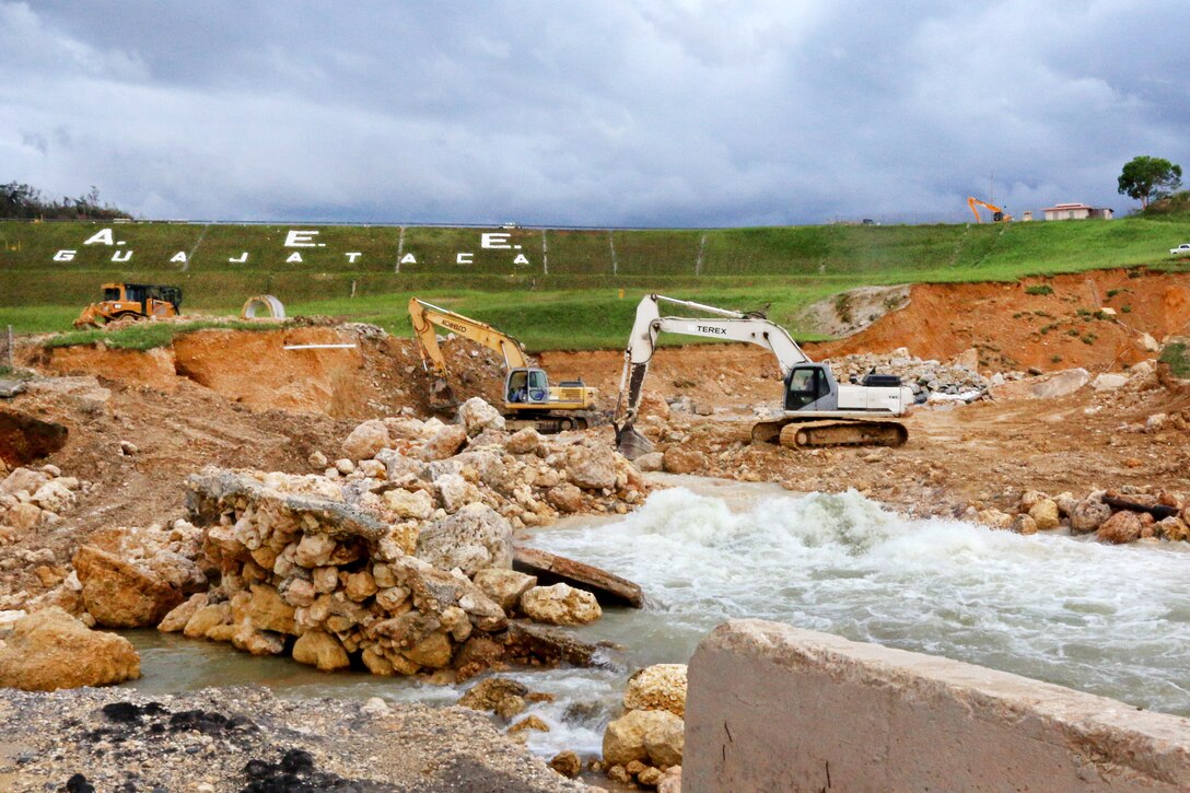Local contractors through the U.S. Army Corps of Engineer help regulate the spillway of the 89-year-old Guajataca Dam.