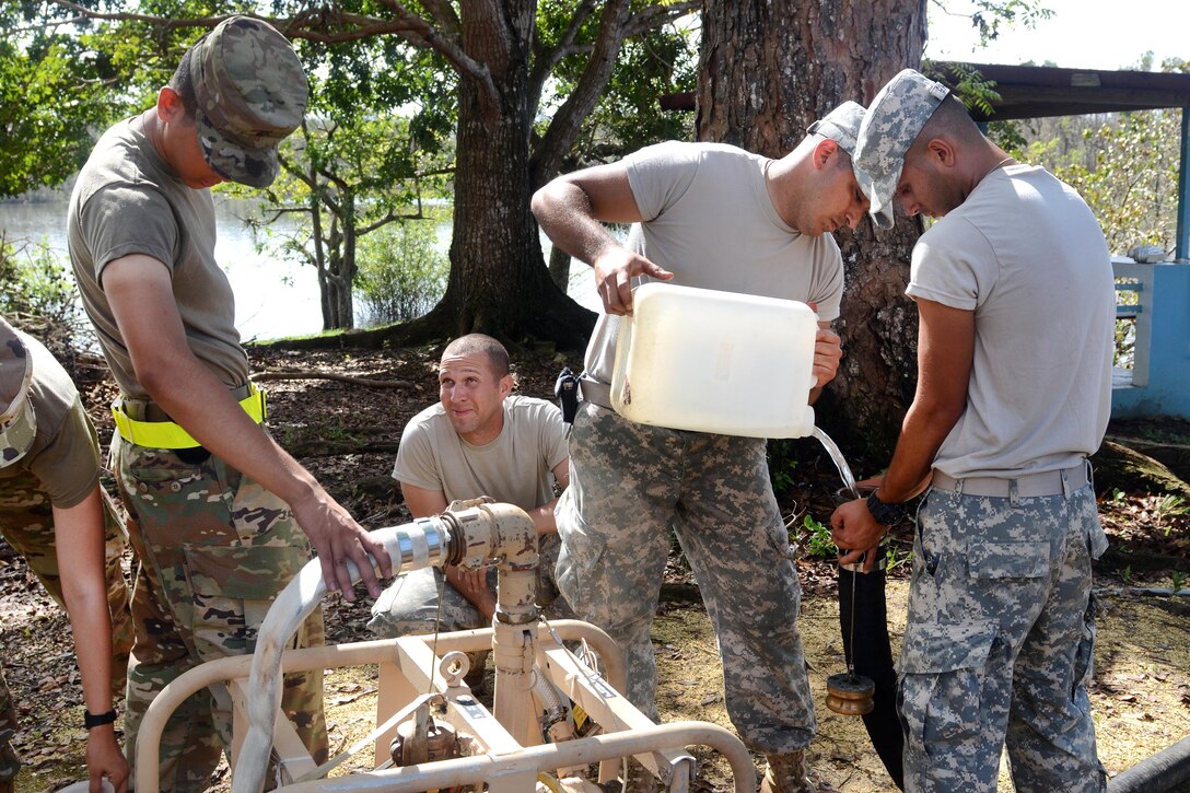 Army Reserve soldiers setup a water pump to begin water purification from Guajataca Lake in Quebradillas.