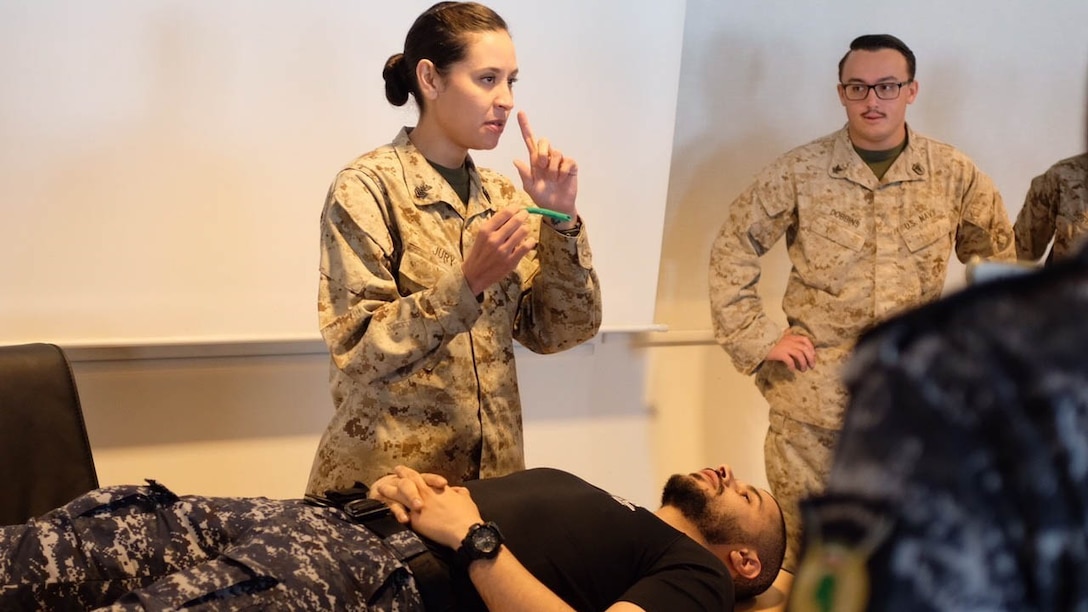 Hospital Corpsman 1st Class Tonya Jury demonstrates placing a nasopharyngeal adjunct during a Tactical Combat Casualty Care Course targeted toward the management of post blast injuries and hemorrhage control during a medical exchange with the Kuwaiti Ministry of Interior explosive ordnance team in Kuwait. The 15th MEU is deployed with the America Amphibious Ready Group in order to maintain regional security in the U.S. 5th Fleet area of operations.