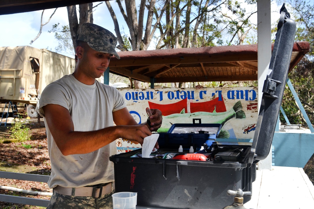 Army Reserve Spc. Bryan Gonzalez test water from Guajataca Lake, Quebradillas.