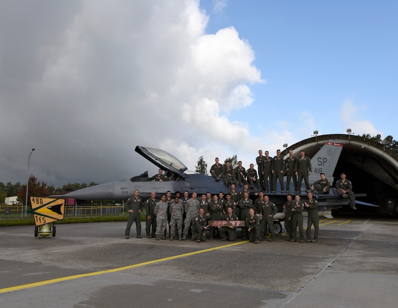 Members of the 480th Fighter Squadron stand near an F-16 Fighting Falcon assigned to the Squadron, October 3rd, 2017.