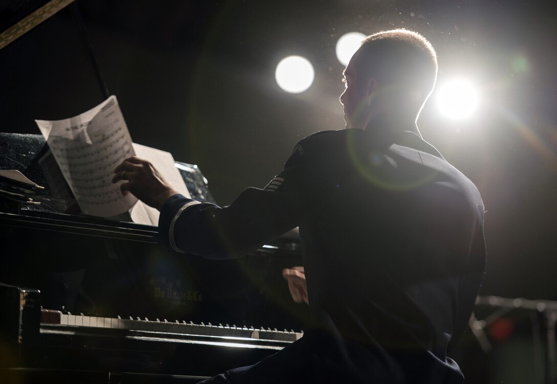 Piano Player turns page of music