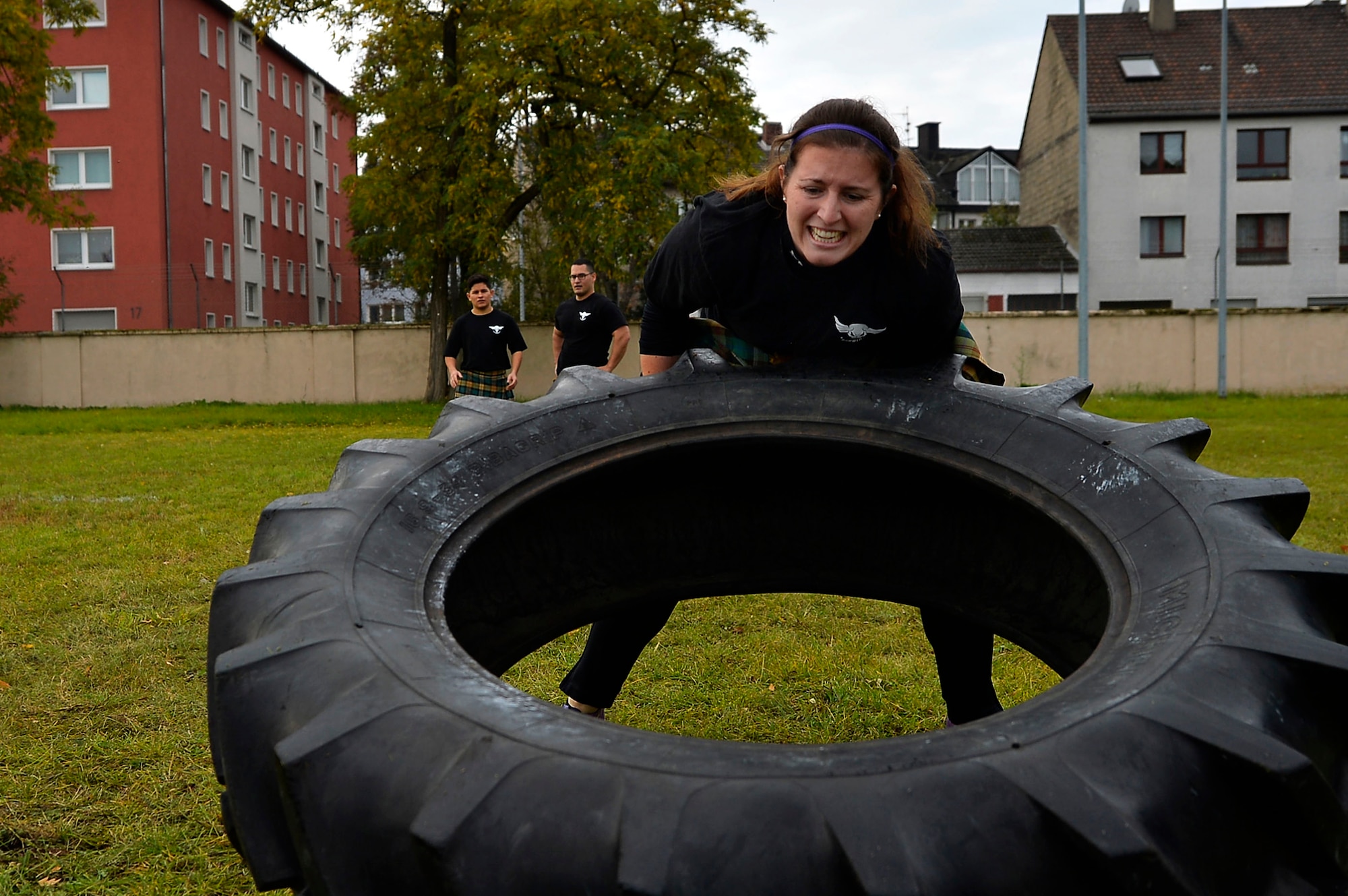 U.S. Air Force 1st Lt. Courtney Sheeks, 450th Intelligence Squadron Central Command analysis team director, participates in a tire flip event during the 693rd Intelligence, Surveillance, and Reconnaissance Group’s Highland Games at Wiesbaden, Germany, Oct. 11, 2017. Other sporting events during the games included hammer throw, humvee pull, axe throwing and log toss. (U.S. Air Force photo by Airman 1st Class Joshua Magbanua)