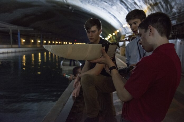 A 3-D printed boat created by student interns currently assigned to Naval Surface Warfare Center, Carderock Division under the Science and Engineering Apprenticeship Program, navigates an obstacle course in the David Taylor Model Basin during the Additive Manufacturing (AM) Challenge in West Bethesda, Md., Aug. 10, 2017. These students designed and created additively manufactured boats using a standard kit of parts and raced them in the basin to complete the event, which is sponsored by the Naval Sea Systems Command 05 Chief Technology Office. (U.S. Navy photo by Dustin Q. Diaz/Released)