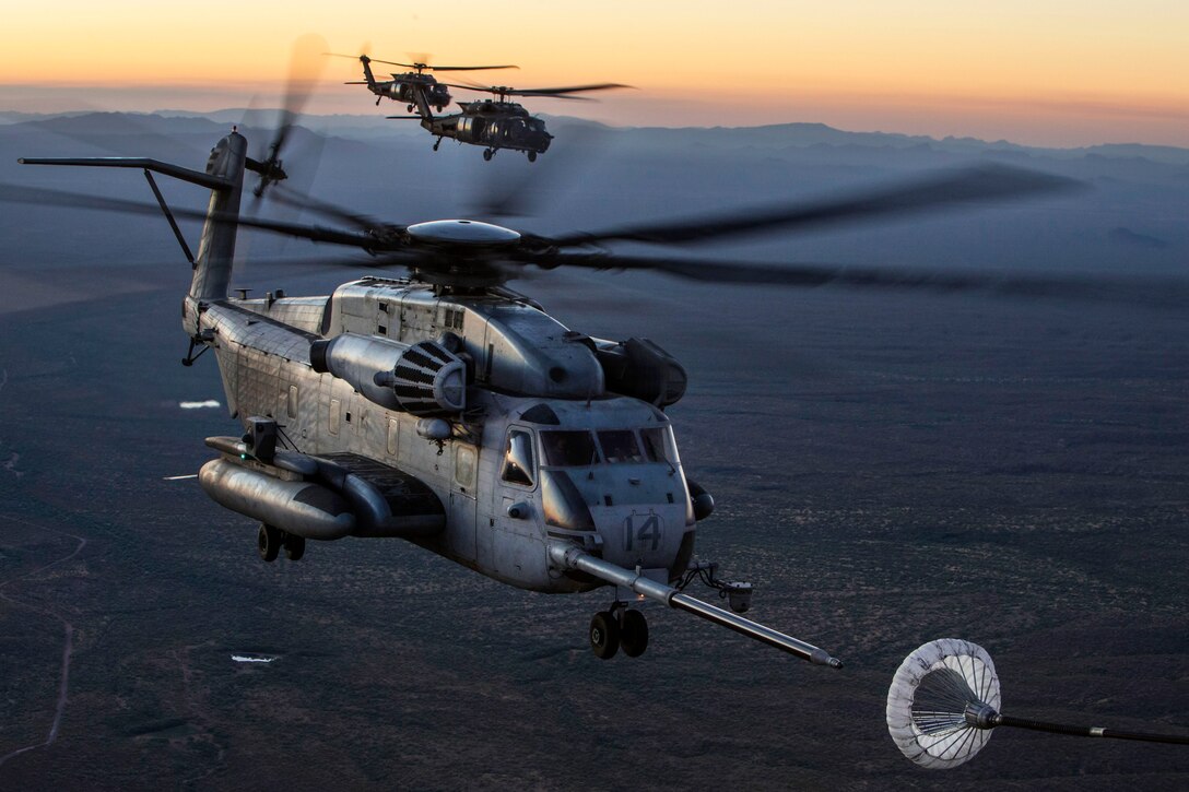 Helicopters conduct an aerial refueling exercise during weapons and tactics Instructor course.