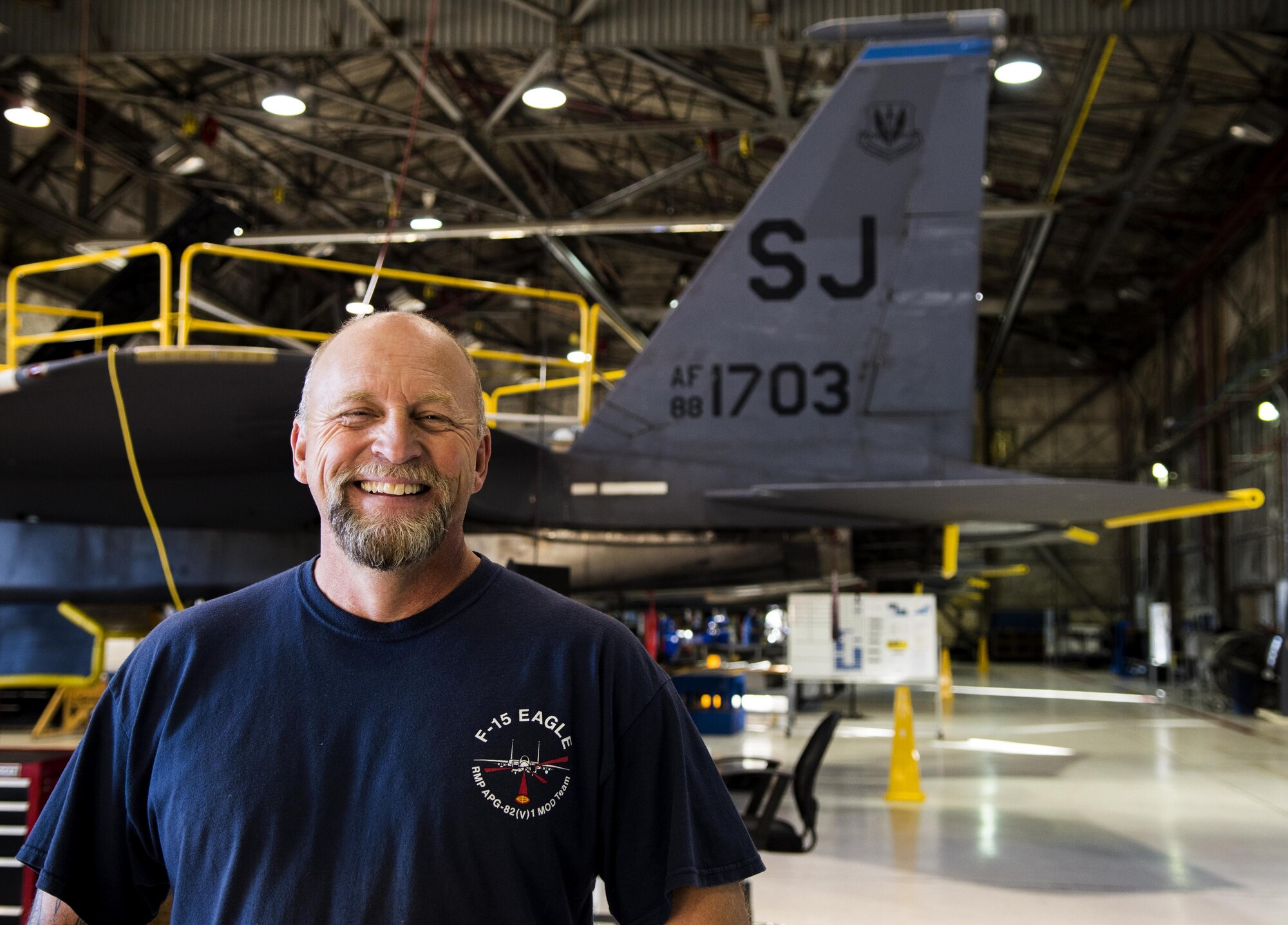 Charlie Loy, Boeing Co. general mechanic, works on F-15E Strike Eagles, installing the radar modifications.