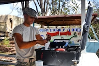 Army Reserve Spc. Bryan Gonzalez test water from Guajataca Lake, Quebradillas.