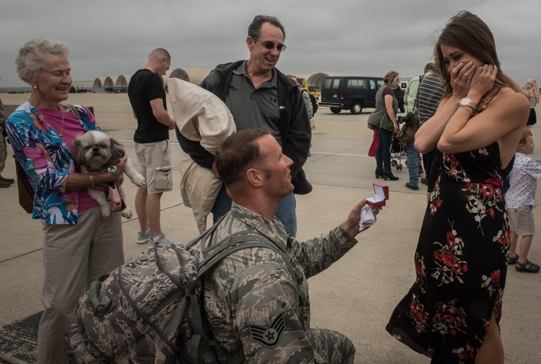 Virginia Air National Guard Staff Sgt. Jeff Greenquist, 192nd Maintenance Squadron low observable technician, proposes to his girlfriend Ashley Branham, after returning from a six-month deployment from the Middle East with the 1st Fighter Wing at Joint Base Langley-Eustis, Va., Oct. 12, 2017. The deployment consisted of F-22 Raptors and Airmen representing the 1st FW in Operation Inherent Resolve against ISIS. (U.S. Air Force photo by Staff Sgt. Carlin Leslie)