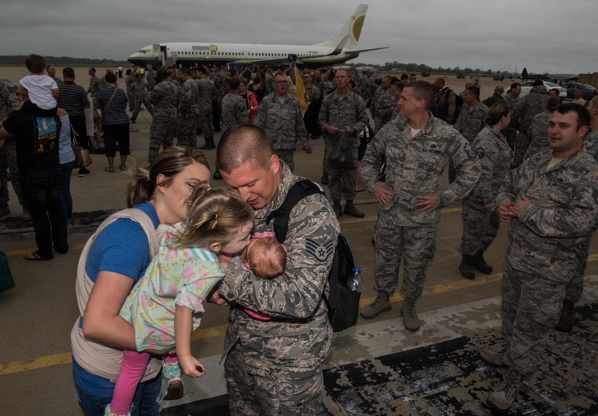 U.S. Air Force Staff Sgt. Spencer Chamber, 1st Maintenance Squadron metals technology technician, hugs his new born baby Xanthe, who he has never met, after his return from a six-month deployment to the Middle East in participation of Operation Inherent Resolve, Joint Base Langley-Eustis, Va., Oct. 12, 2017.  Spencer, was deployed with members of the 27th Aircraft Maintenance Unit and Virginia Air National Guard Airmen assigned to the 192nd Fighter Wing. (U.S. Air Force photo by Staff Sgt. Carlin Leslie)