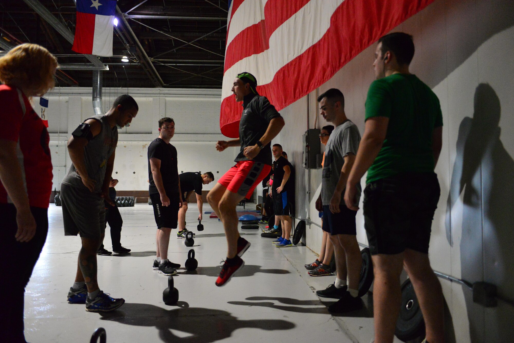 Airman 1st Class Crayton Noe demonstrates a strength-training activity for Run Clinic attendees at the Offutt Field House at Offutt Air Force Base, Nebraska Oct. 10, 2017.