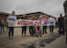 Family of Virginia Air National Guard Staff Sgt. Jeff Greenquist, holds a welcome home sign, celebrating his return from the Middle East at Joint Base Langley- Eustis, Va., Oct. 12, 2017. Greenquist is a low observable technician from the 192nd Maintenance Squadron and was deployed with the 1st Fighter Wing for six months. The deployment consisted of F-22 Raptors and Airmen representing the 1st FW in Operation Inherent Resolve against ISIS. (U.S. Air Force photo by Staff Sgt. Carlin Leslie)