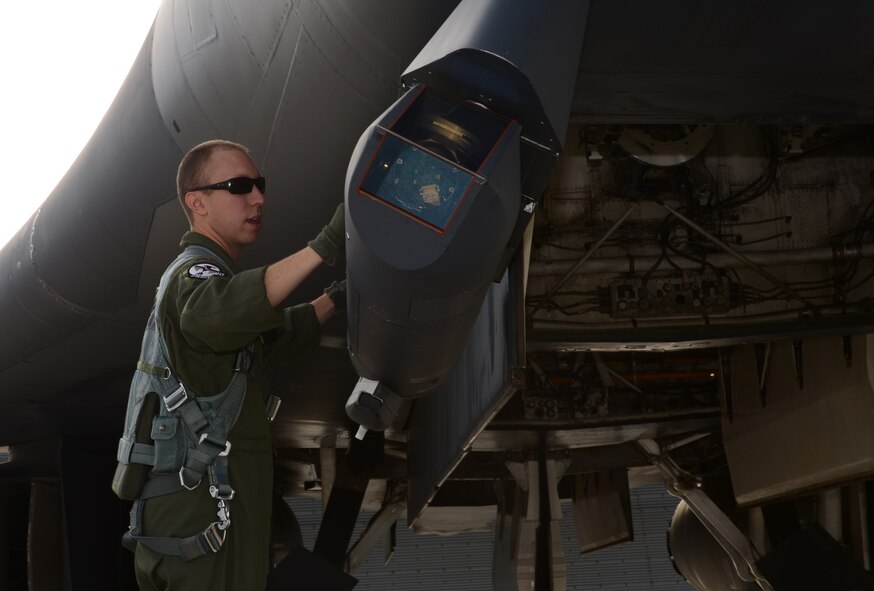 1st Lt. Thomas, a weapon systems officer assigned to the 34th Bomb Squadron, inspects the sniper pod on a B-1 bomber before take-off as part of exercise Combat Raider 18-1 at Ellsworth Air Force Base, S.D., Oct. 11, 2017. This exercise introduces aircrew to various air-to-air and air-to-ground scenarios to ensure they are well prepared for future combat missions. (U.S. Air Force photo by Airman 1st Class Donald C. Knechtel)